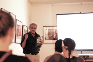 Aditya Arya, holding a copy of, 'Re-imaging the people of India.'